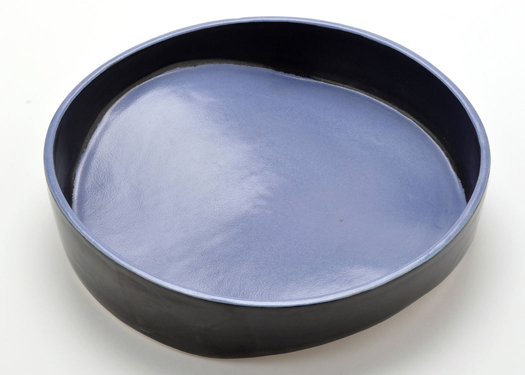 Attributed to Will Levi Marshall: a black and pale blue Studio pottery dish, with shaped base,