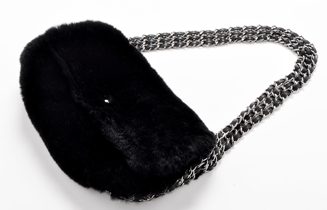 Chanel: A black rabbit fur handbag, with triple metal and leather chain linked strap,