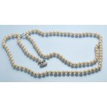 Chanel: a faux pearl belt, with monogram drop, 42cms (16 1/2in.) long when closed.