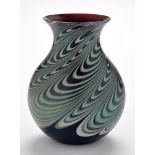 Okra: An iridescent glass vase, with swirl decoration on blue ground, signed R.F.O. 17.5cms (7in.