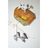 A pair of silver "Chow" dog brooches; together with a cold painted metal dog mounted onyx ashtray.