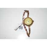 A 9ct. gold wristwatch, the white enamel arabic dial on flexi baton strap.