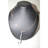 An 18ct. yellow gold bow and chain link pattern necklace, 68cms. long, 10grms. gross.