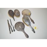 A silver backed dressing table hand brush and matching mirror; another silver backed hand mirror;