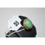 A turquoise coloured stone ring, the cabochon stone collet set,