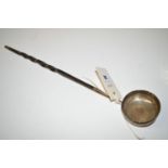 A white metal toddy ladle, the bowl set George II coin, with twisted whalebone handle.