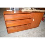 A modern teak bookcase, with open shelves to left hand side and a cupboard door to the right.