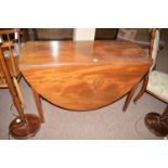 A Georgian mahogany drop-leaf dining table, the oval top above plain frieze,