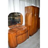 An early 20th Century figured walnut three-piece bedroom suite, to include: wardrobe,