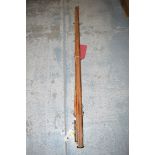 An old cane fishing rod in three sections with spare tip, and a custom made wooden protector.