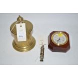 A brass door stop; a reproduction ship's style clock in brass and mahogany mount;