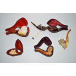 A collection of carved meerschaum pipes in various forms (four cased).