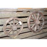 A small wooden wheel; and an even smaller matching wooden wheel.
