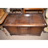 A mid 20th Century stained oak blanket box with linen fold panel to front,