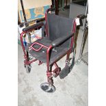 A folding invalid chair with maroon metal frame.