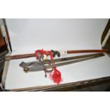 A reproduction Japanese sword and scabbard; and two other reproduction swords.