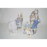 Three Lladro figures modelled as clowns; together with a "Lladro Society" plaque with dove.