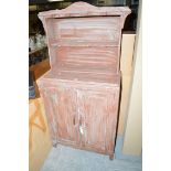 A painted kitchen cabinet, the open shelves above two cupboard doors.