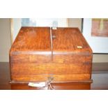 A early 20th Century oak correspondence case with sloping front,