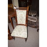 A Victorian walnut nursing chair, the upholstered back flanked by a turned upright,