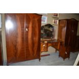 A reproduction mahogany bedroom suite, to include: a wardrobe, a lady's wardrobe, dressing table,