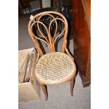 Three Thonet Bentwood occasional chairs with cane seats, raised on turned tapering legs.