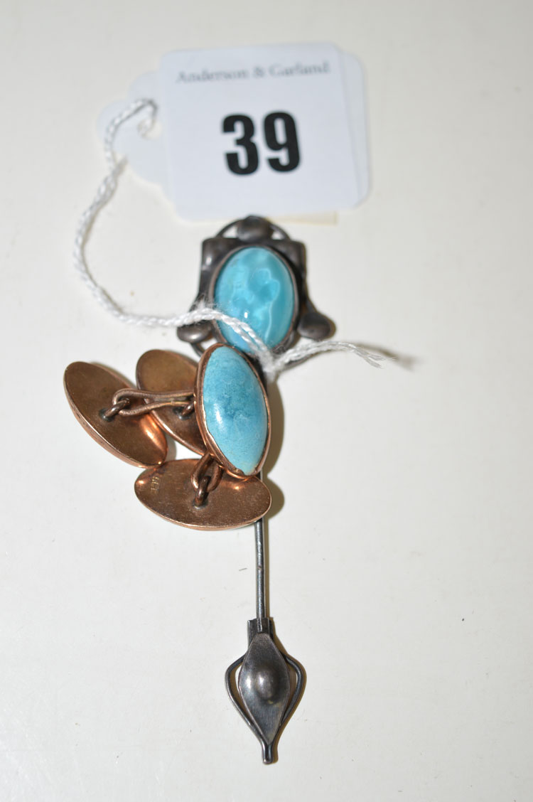 A turquoise coloured stone cabochon set Arts & Crafts pattern tie pin;