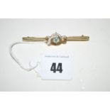 An aquamarine and seed pearl set bar brooch, stamped 15ct.