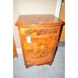 A burr walnut bedside cabinet, the bowfront fitted a single drawer and cupboard door.