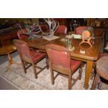 An early 20th Century oak extending dining table,