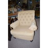 An Ethan Allen Home Interiors button-back easy chair, raised on turned tapering legs.