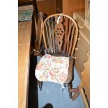 A set of four elm seat Windsor chairs, with spindle and pierced backs,