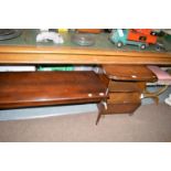 A reproduction mahogany coffee table; a stained walnut canterbury;