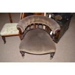 A Victorian stained wood easy chair with shaped buttoned back, raised on turned spindle supports,