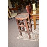 An early 20th Century stained wood stool with shaped seat,