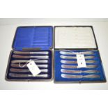 Two sets of six tea knives with silver filled handles, in fitted cases.