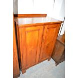 A Victorian mahogany side cabinet, the panel doors opening to reveal drawers and shelving,