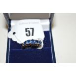A five stone sapphire ring, the oval graduated facet cut stones claw set to a yellow metal shank,