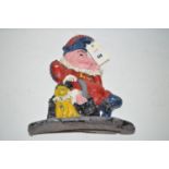 A cast lead door stop in the form of Mr. Punch and his dog (recently repainted).