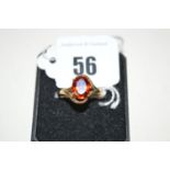 A hessonite garnet ring, the oval facet cut stone claw set within crossover mount, on 9ct.