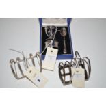 Two five bar silver toast racks; together with a silver three-piece breakfast set of egg cup,