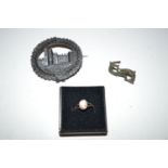 A carved jet brooch of Kilkenny Castle; a small shell cameo ring;