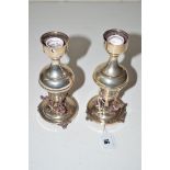 A pair of 800 standard silver candlesticks with figural stem bases.