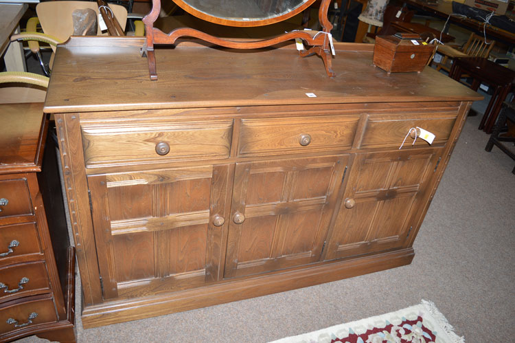 An Ercol dining suite in dark stained elm,