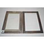 Two Indian white metal mounted photograph frames, decorated with foliate scrolls.