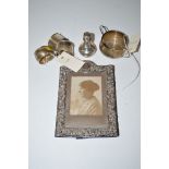 A silver mounted photograph frame; three silver napkin rings; a two-handled sugar bowl;