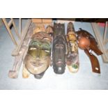 A collection of hand carved and painted tribal masks; and other artifacts.