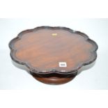 A mahogany Lazy Susan on circular base.