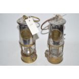 Two miner's safety lamps.