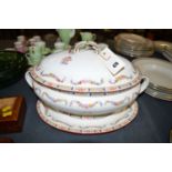 A large oval two-handled Minton tureen, cover and oval stand, with floral spray decoration.